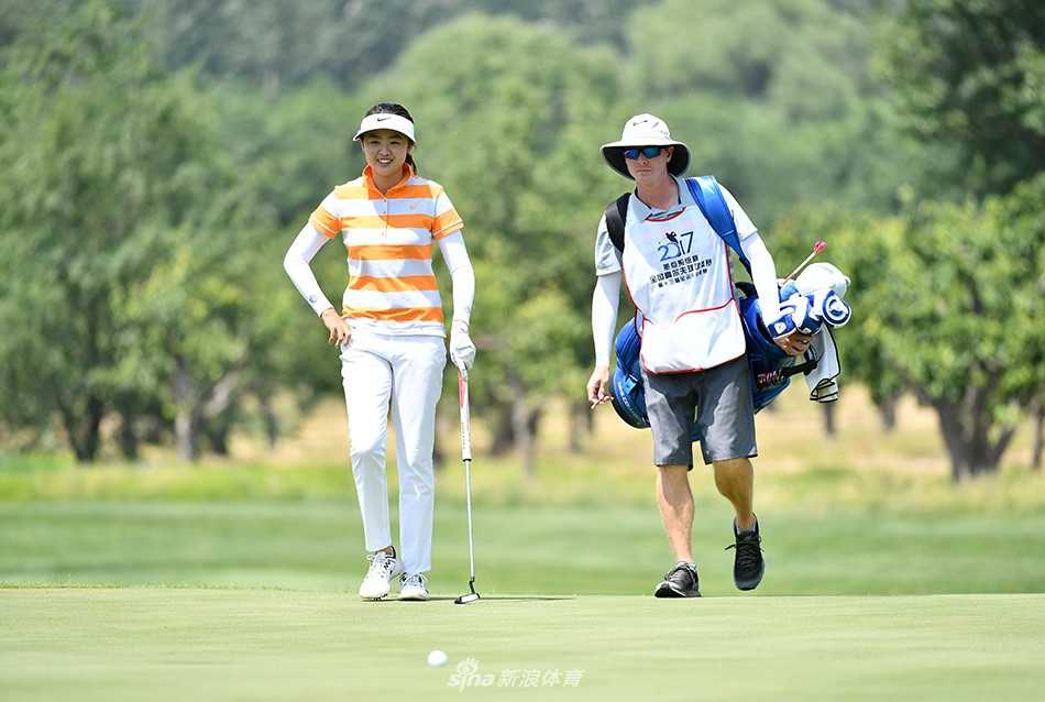 冯思敏全神贯注准备开球，背景是开阔的球场与蓝天