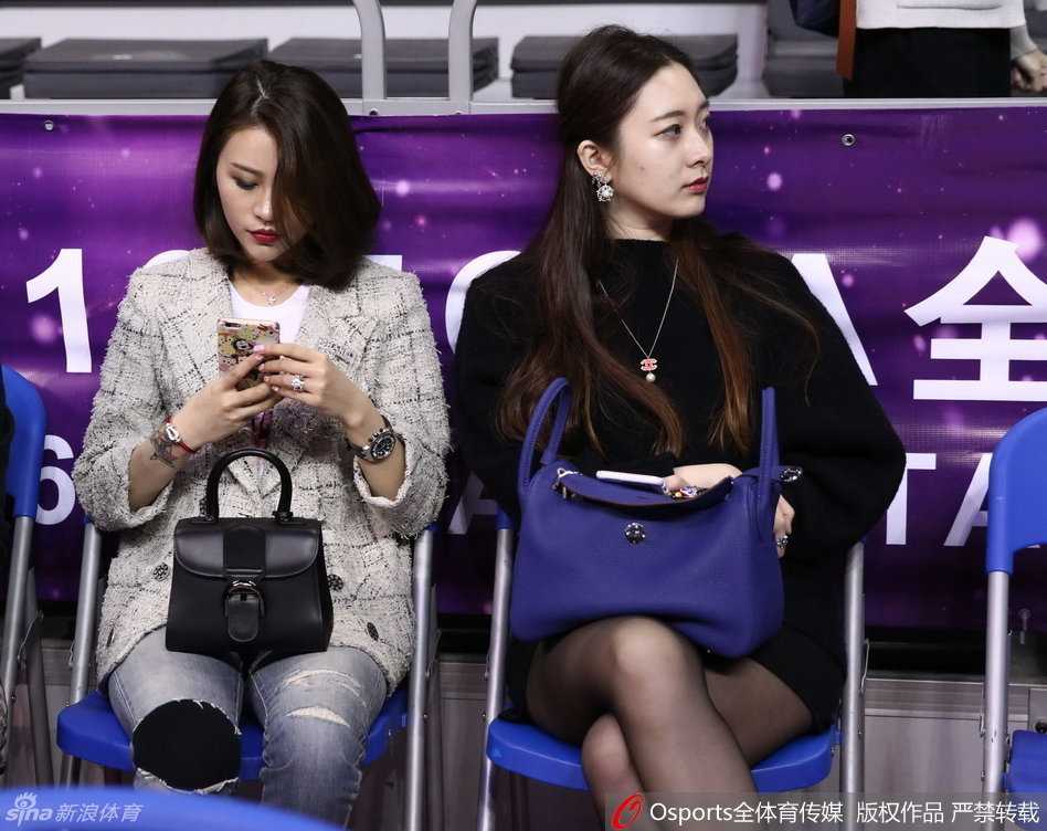 陈露身着一袭时尚装扮现身看台，标志性的红唇妆容尽显女王风范，在人群中熠熠生辉。