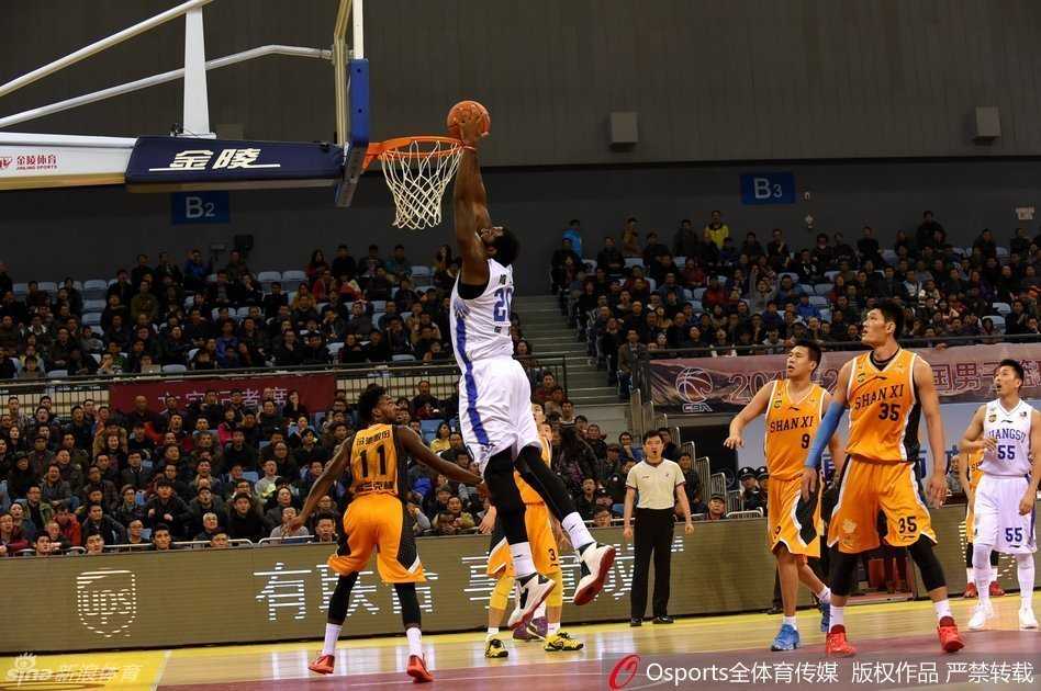 江苏队核心易立在运球突破时，冷静地观察队友跑位，单手将球传向切入篮下的队友，展现出他作为锋线核心的全面视野和团队意识。