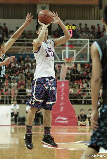 赛后，获胜的广东工业大学球员们围聚在场地中央，将手叠在一起高声呼喊加油，汗水在灯光下闪烁，凝聚着团队的信念与胜利的喜悦。