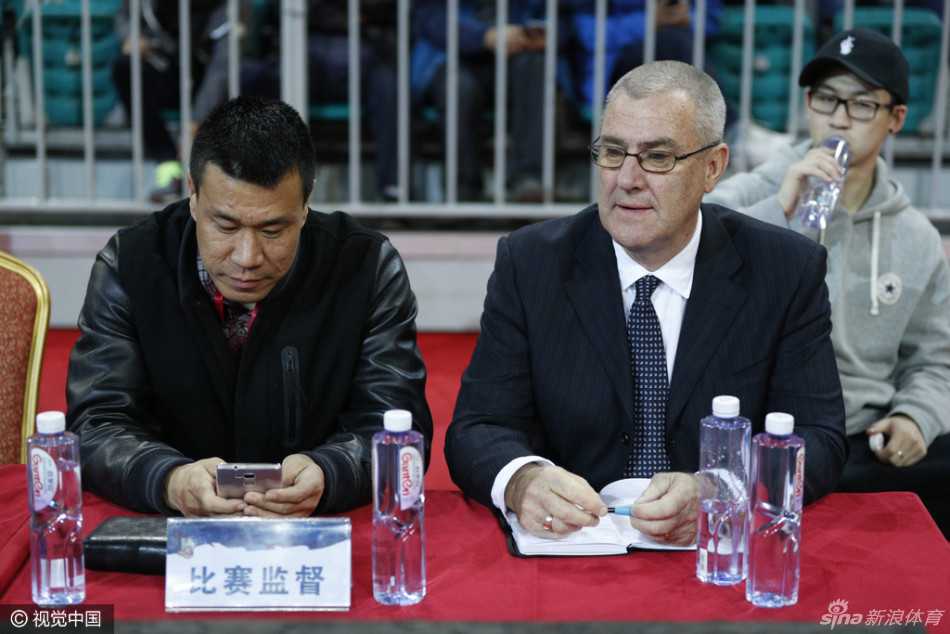 上海队外援斯图尔特在三人包夹下强行起跳上篮，身体在空中扭曲成一道弓形，展现出惊人的核心力量。