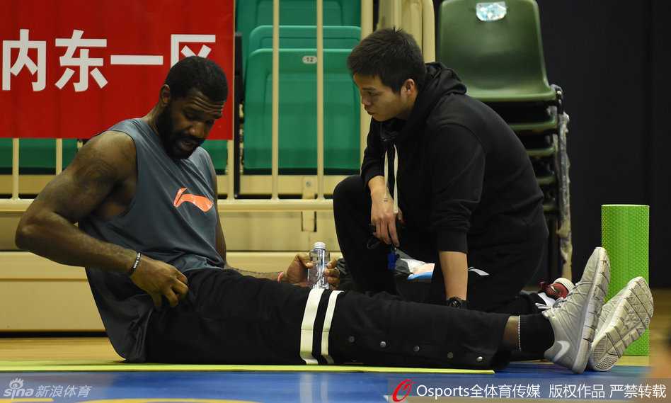 热身间隙，北控队的外援查尔斯利用短暂休息时间调整呼吸，坚定的目光望向前方，肌肉线条在灯光下清晰可见，力量感十足。