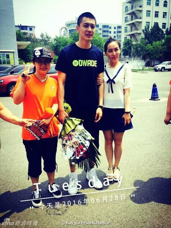 阳光下的杨鸣面带温暖笑容，与一群兴奋的女学生粉丝亲密合影，瞬间引爆了毕业典礼的现场气氛。