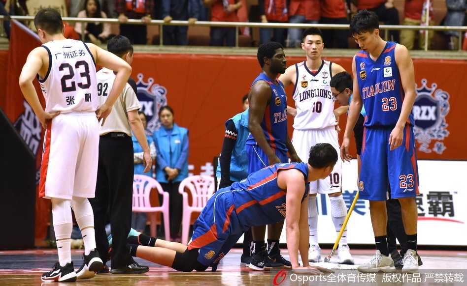 双方队员围成一团，场面陷入混乱，一名球员的手臂高高扬起，旁边的裁判奋力吹响哨子试图控制局面，看台上的观众也纷纷起立关注场内动态。