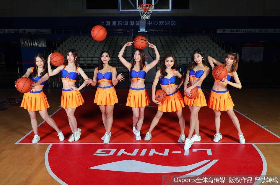 全体篮球宝贝在表演结束后集体向观众致意，她们手拉手鞠躬感谢，背景的大屏幕上显示着CBA联赛的标识，现场气氛温馨而热烈。