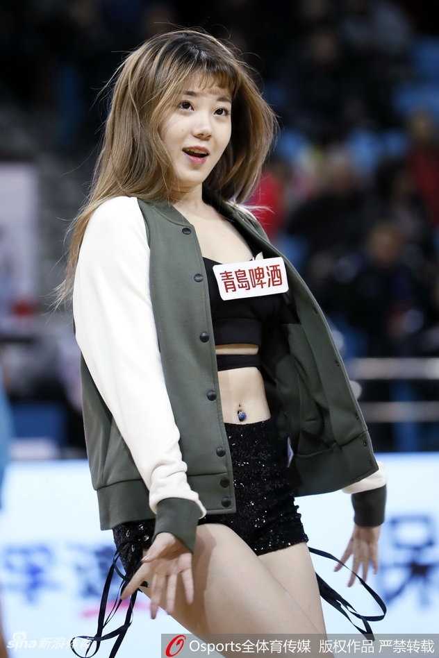 队员高速旋转时秀发与裙摆齐飞，自信微笑直面镜头，定格动感瞬间