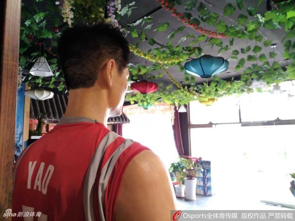 从侧面角度拍摄，蜡像的体型优势尽显无疑，身旁走过的普通人身高仅及他的胸口，这种强烈的身高对比让画面充满了戏剧性