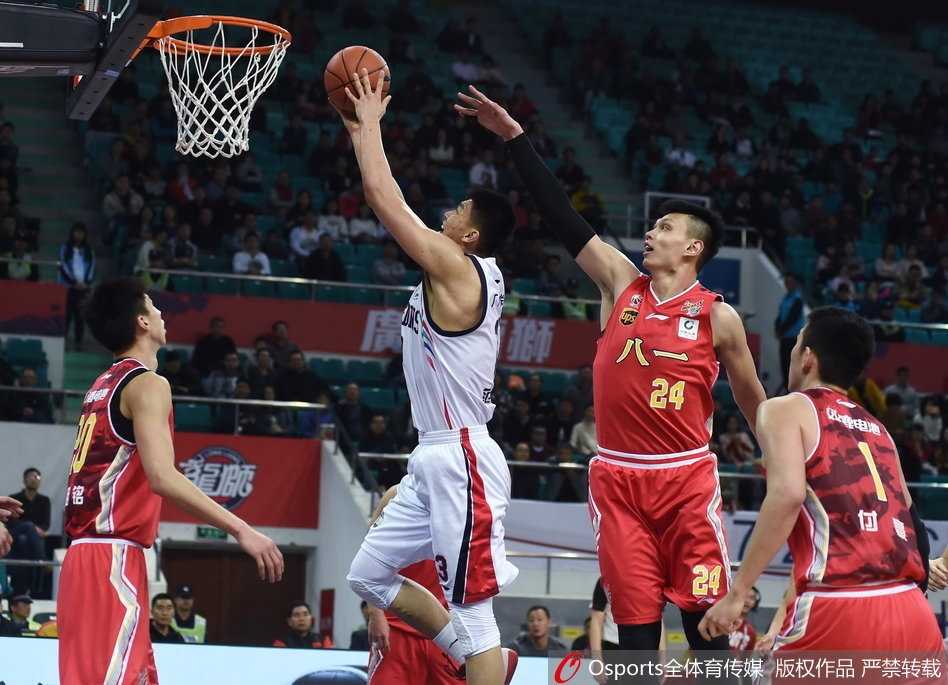 广州队外援汉斯布鲁在八一队内线群中高高跃起，犹如鹤立鸡群般摘下一个宝贵的前场篮板，他的眼神坚毅，肌肉线条在对抗中尽显力量之美。