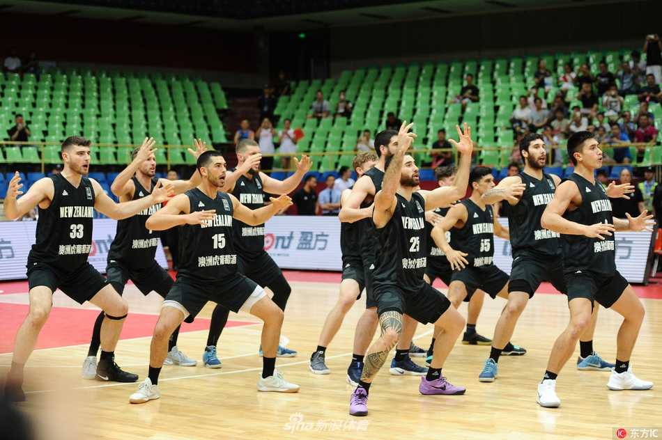 新西兰球员们围成一圈，整齐划一地跺脚、拍打胸口，眼神凌厉地凝视前方，展现毛利战舞的磅礴气势。