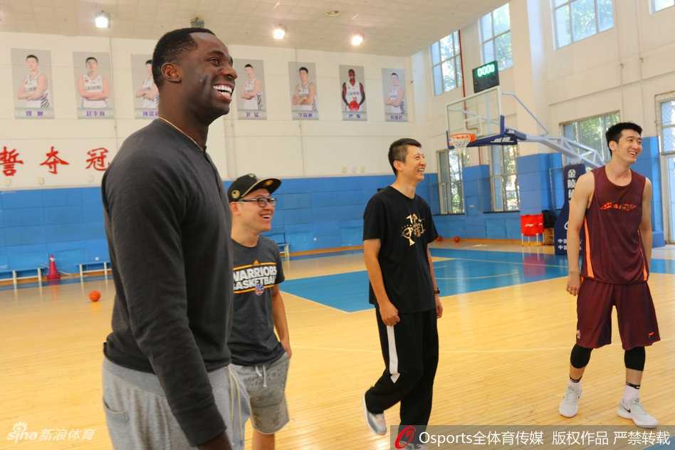 巴斯在训练馆中露出自信的微笑，身后是正在训练的辽篮队员们，新赛季的梦想从这一刻开始起航。