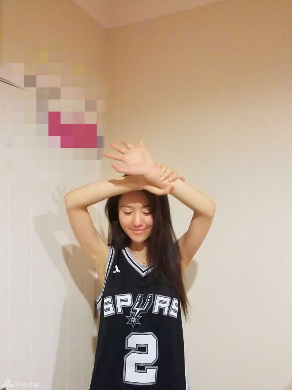 一位阳光的马刺女球迷在球场上轻松上篮，身姿矫健，马尾随风飘扬，笑容里满是对篮球最纯粹的热爱。