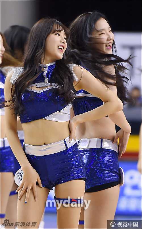 首尔蚕室体育馆内，拉拉队员背对镜头展现优美身姿，专业的舞姿与赛场氛围完美融合。